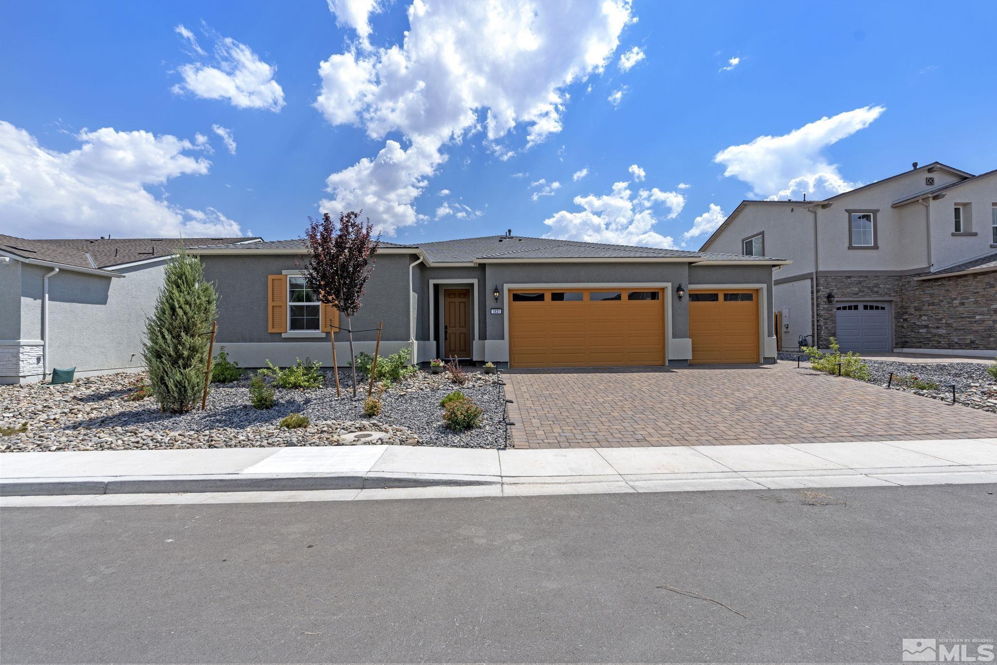 a front view of a house with a yard and a garage