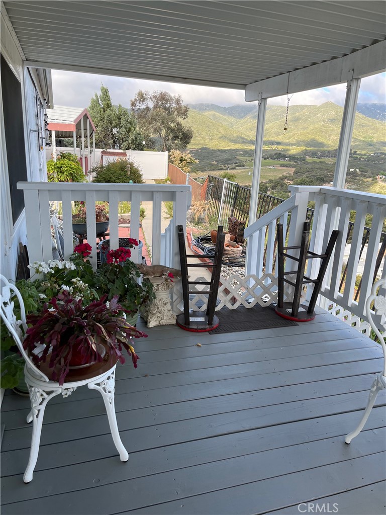 a view of balcony with chairs and potted plants