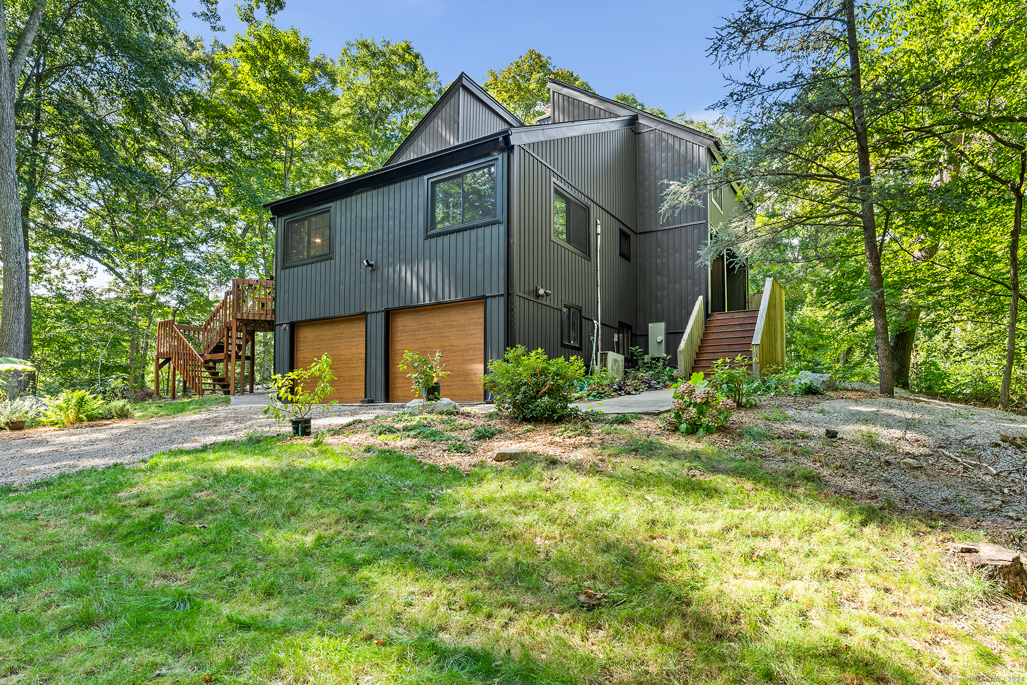 a view of a house with backyard and sitting area