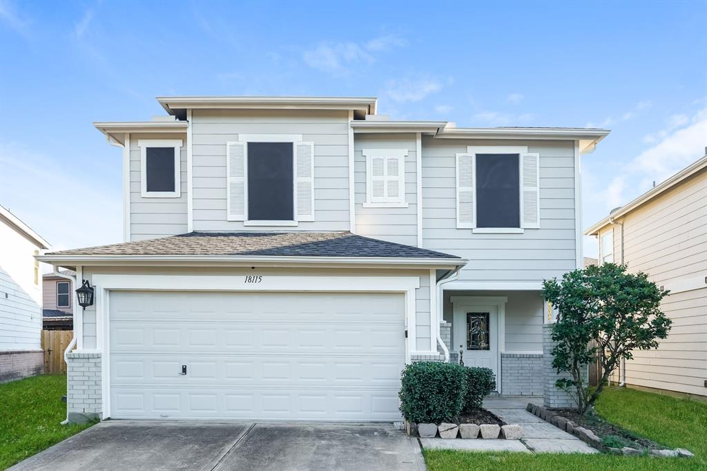 a front view of a house with garage