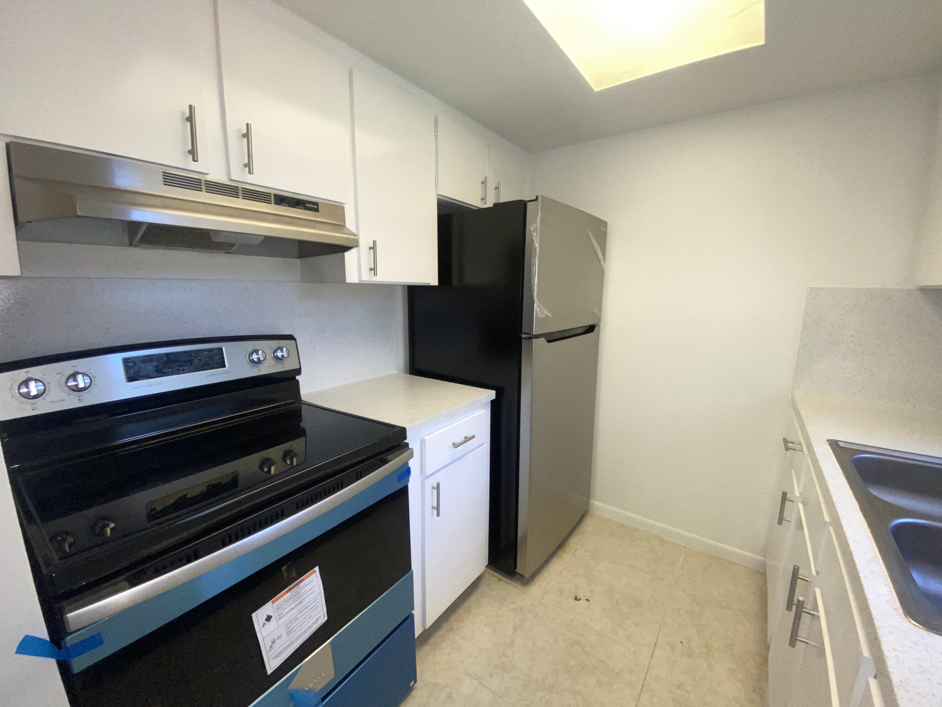 a kitchen with stainless steel appliances a stove and a refrigerator