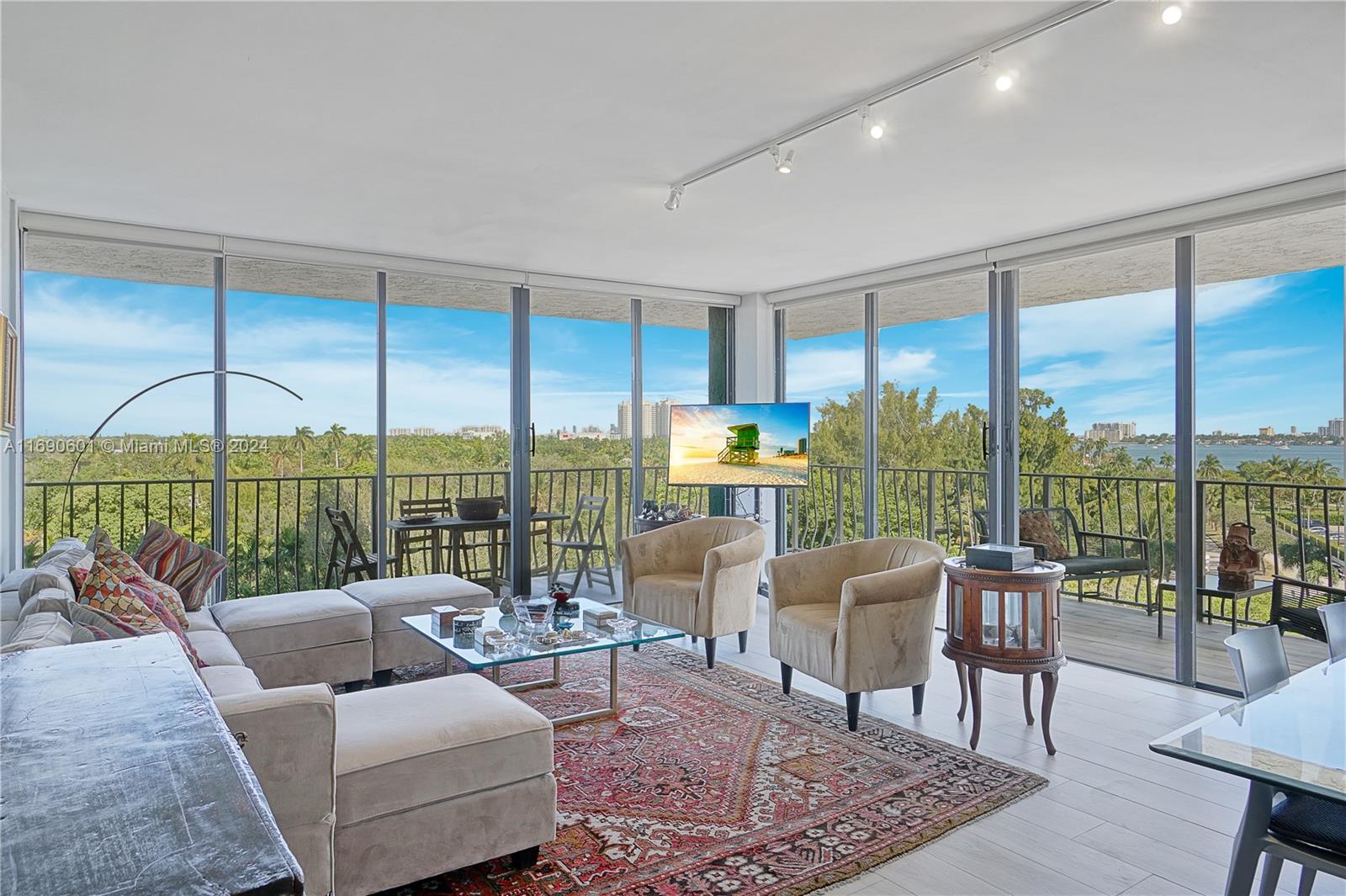 a living room with furniture and a floor to ceiling window