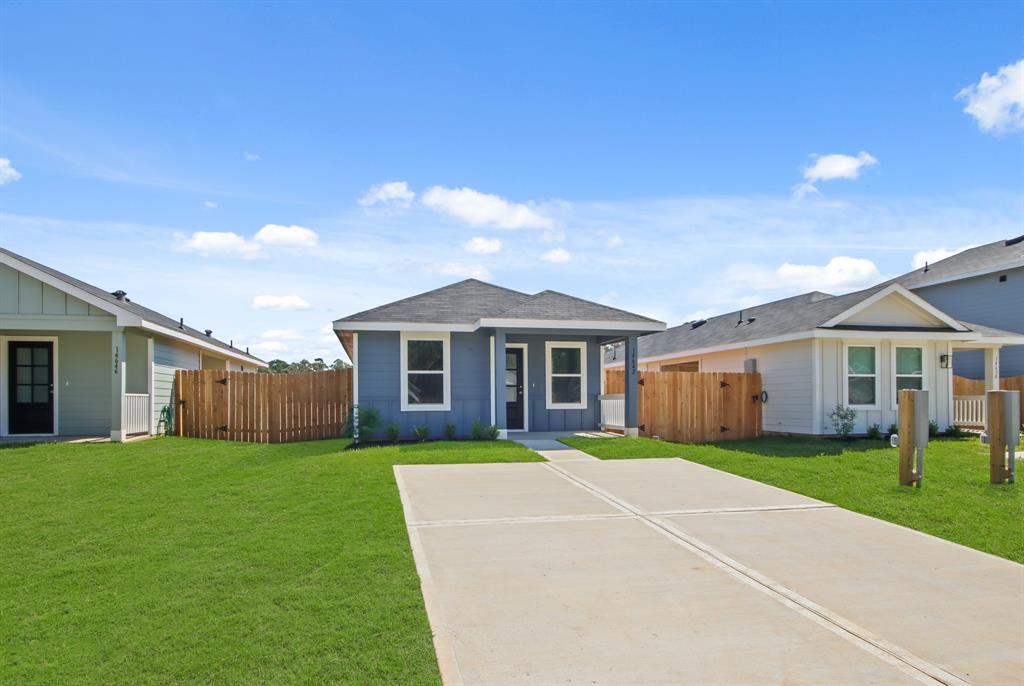 a view of a house with a yard and pathway