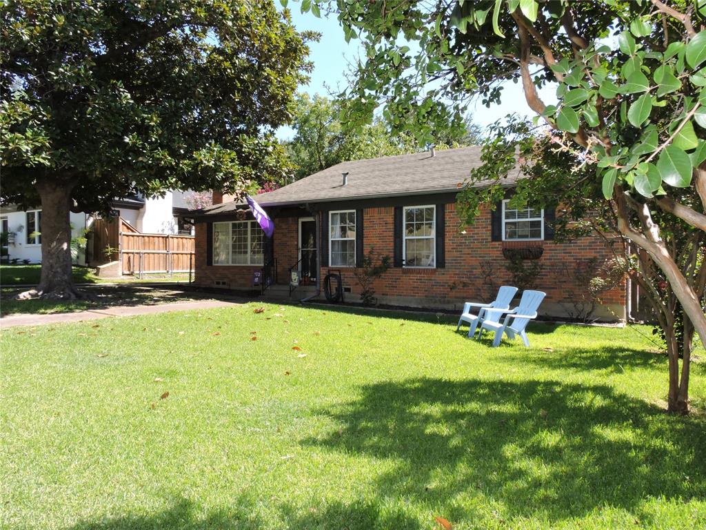 a front view of a house with a yard table and chairs