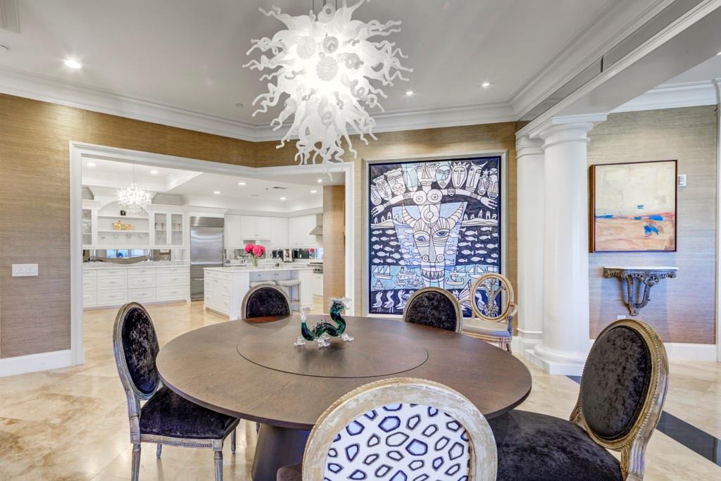 a view of a dining room with furniture and chandelier