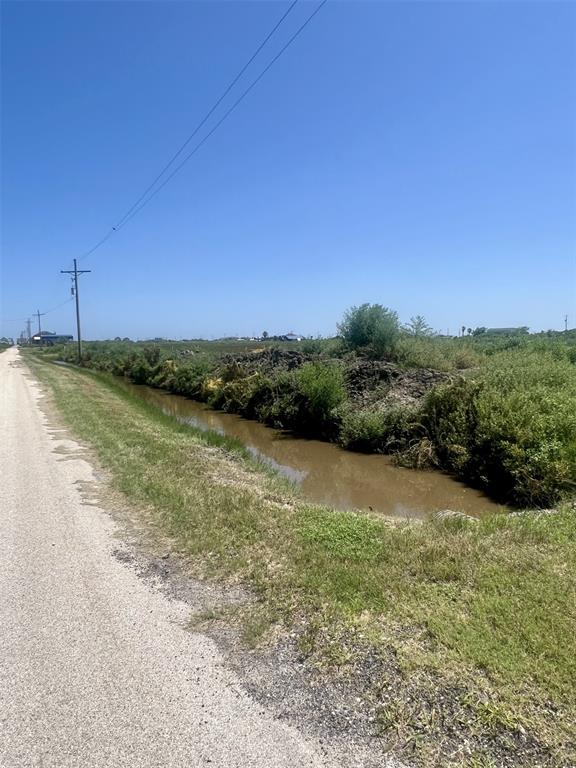 a view of a field with an ocean