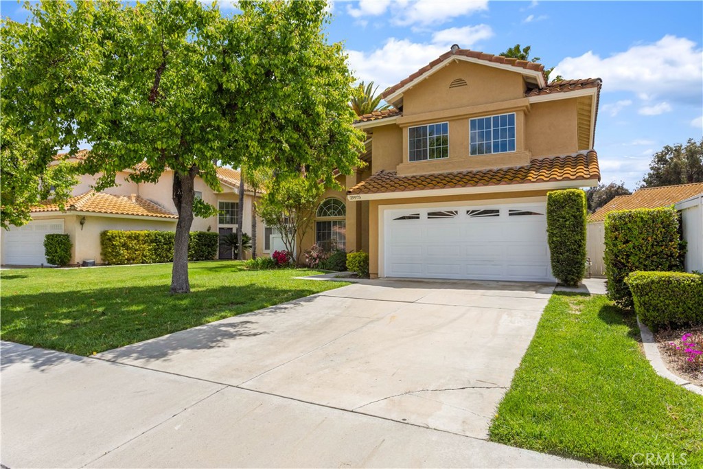 a front view of a house with a yard and a garage