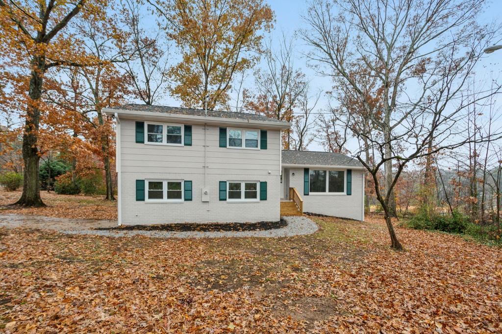 a house that has a tree in front of it