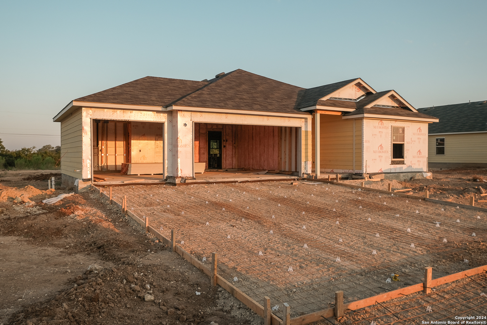 a view of a house with a yard and garage