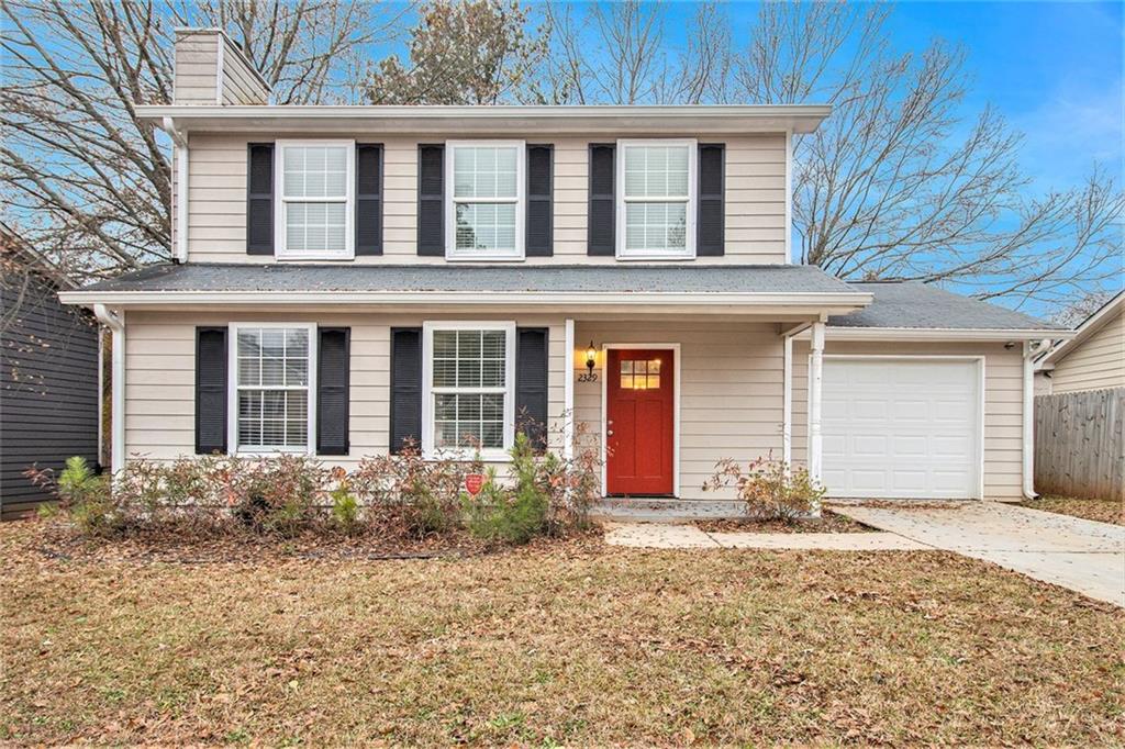 front view of a brick house with a yard