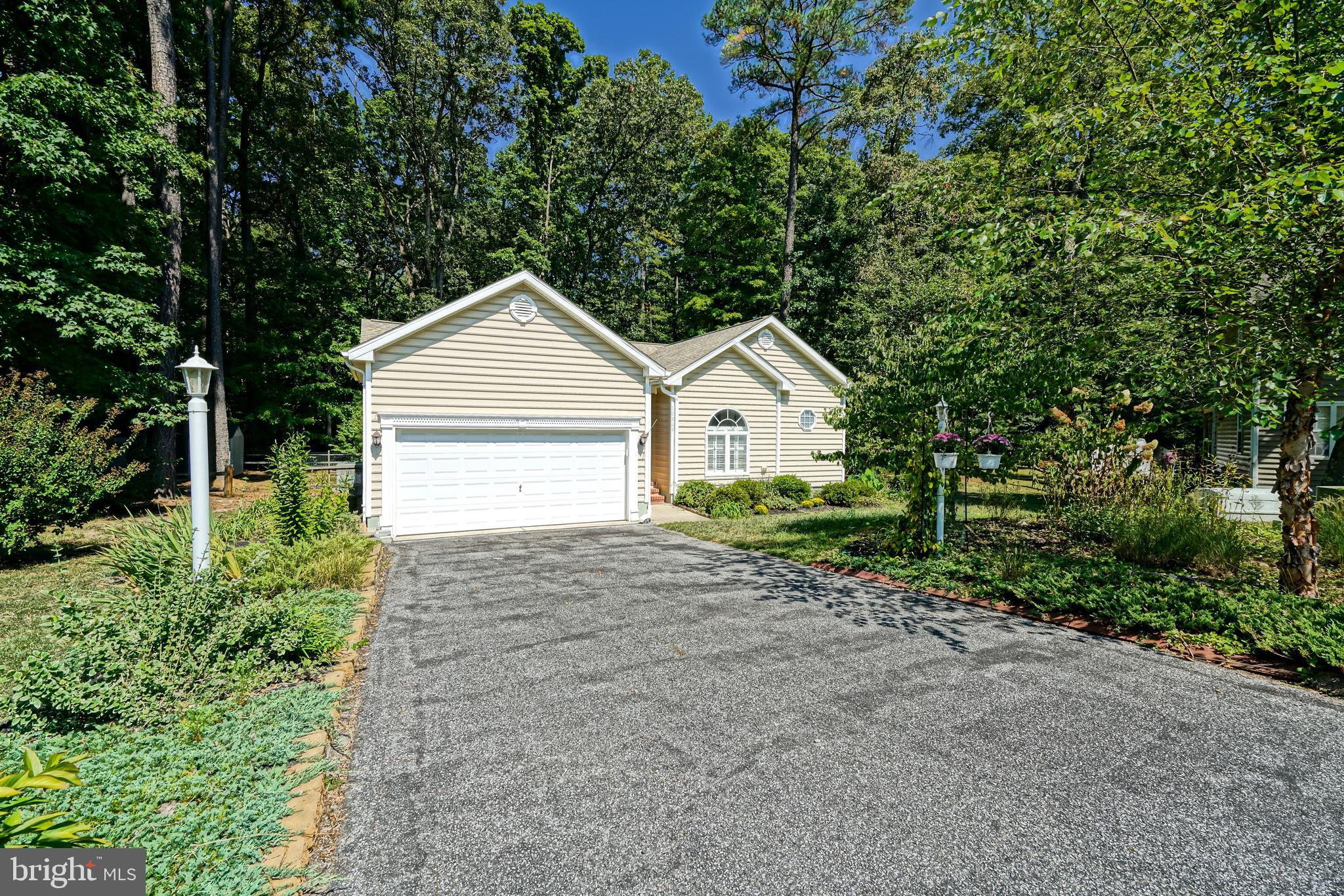 a view of front a house with a yard and garage