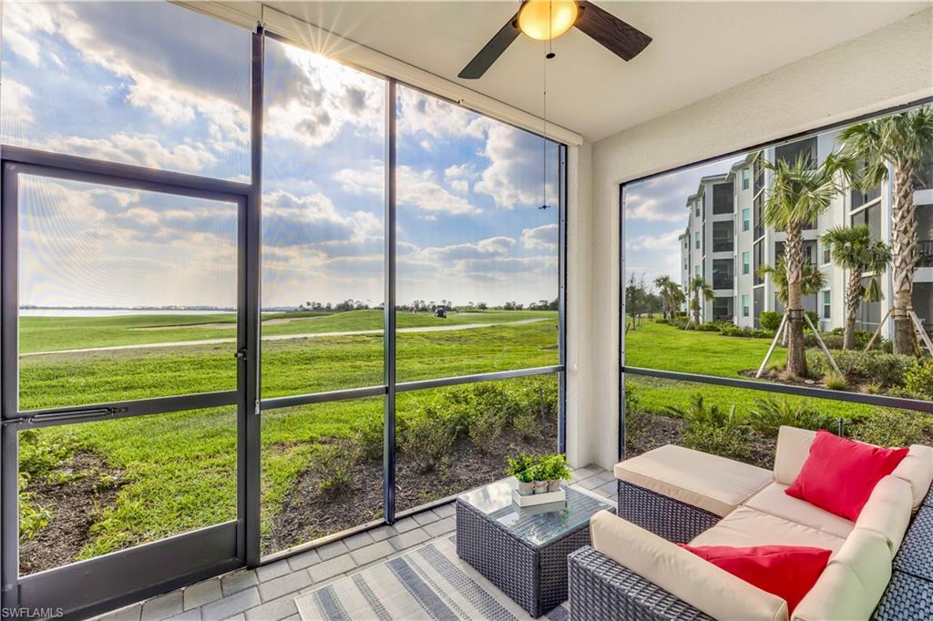 a living room with patio chairs and a floor to ceiling window