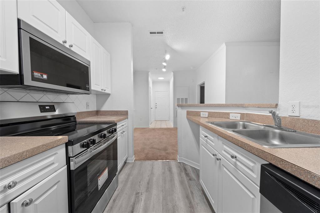 a kitchen with a sink stove and microwave