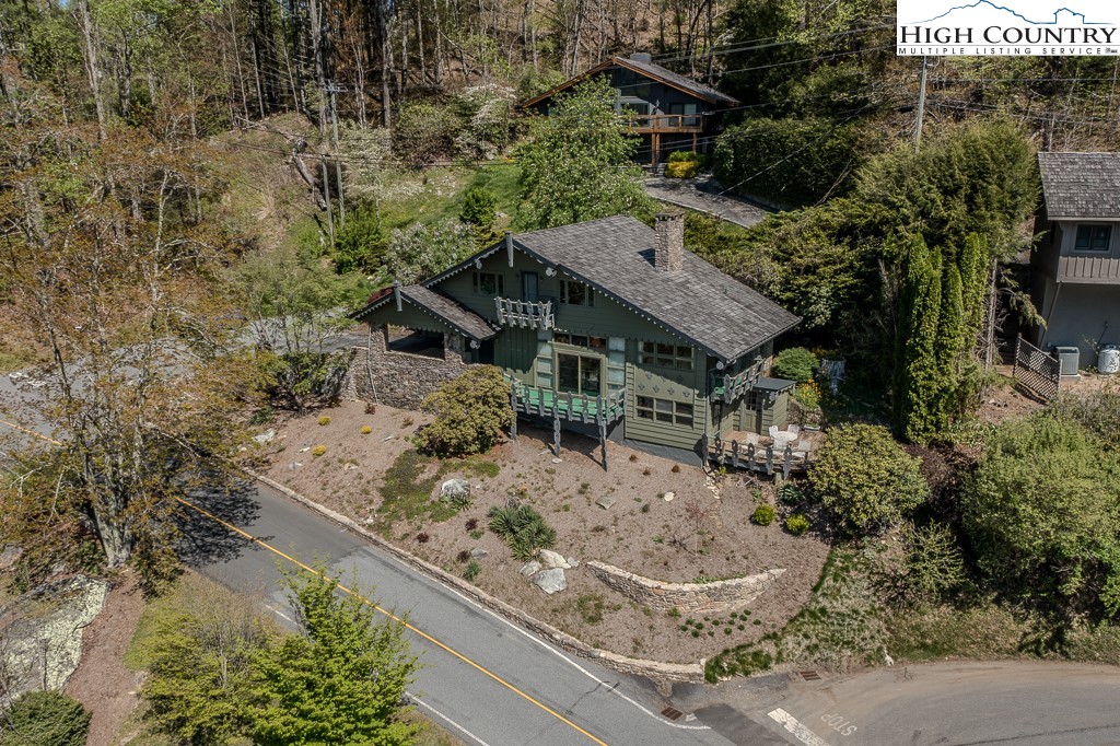 an aerial view of a house with a yard