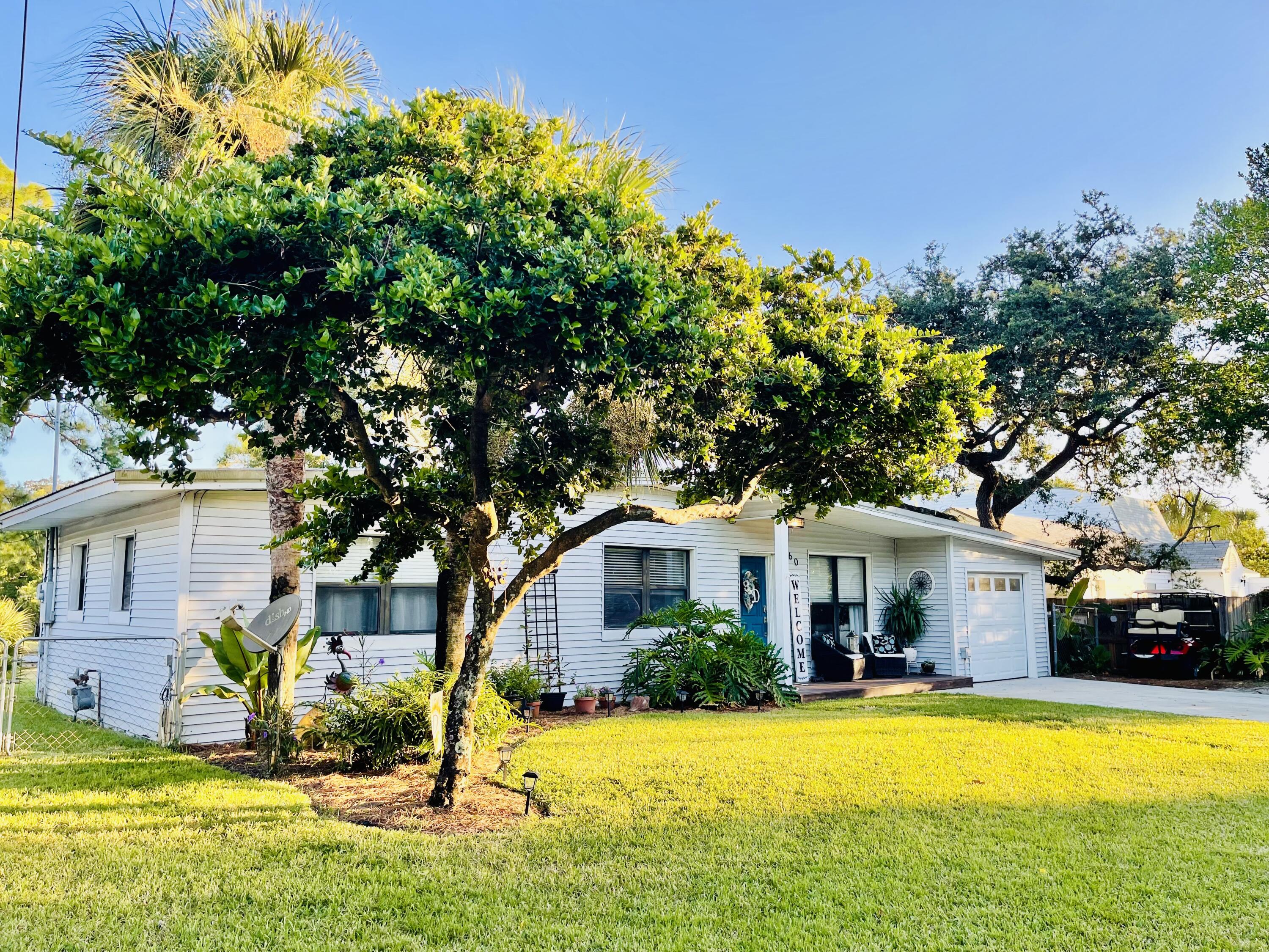 a front view of a house with a yard patio and swimming pool