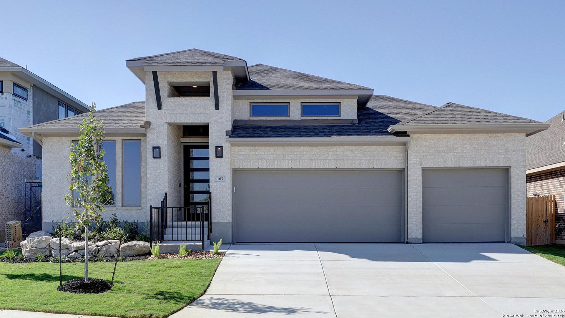 a front view of a house with a yard and garage