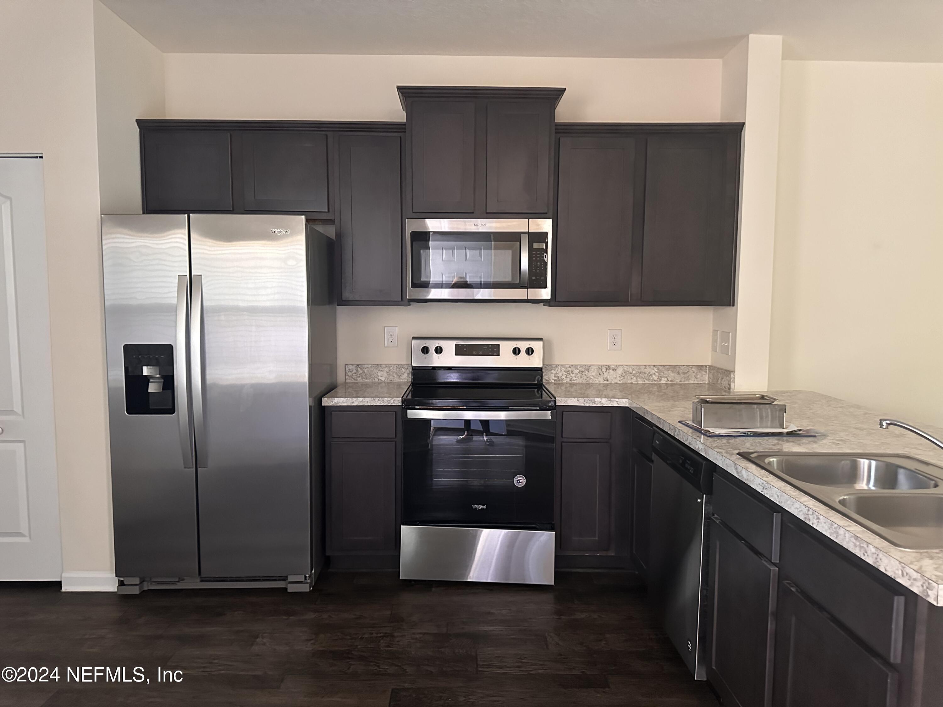 a kitchen with a refrigerator sink and microwave