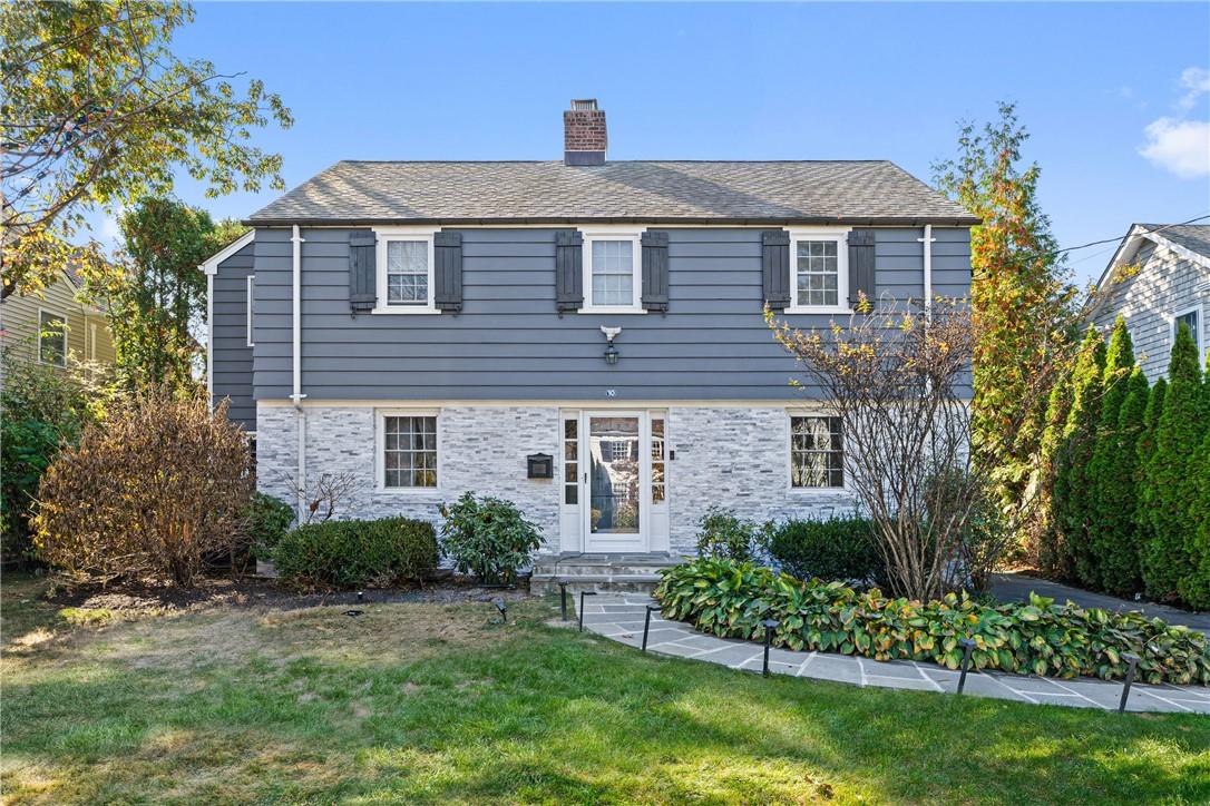 a front view of a house with a garden