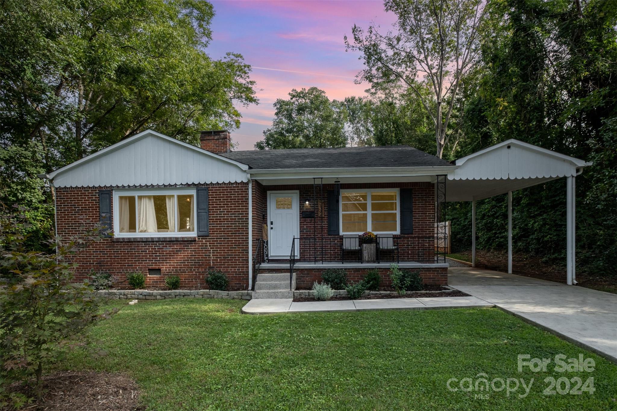 a front view of a house with a yard table and chairs