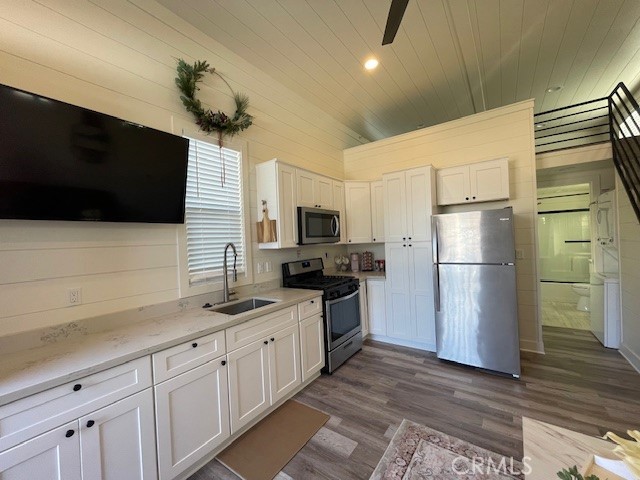 a kitchen with stainless steel appliances a refrigerator sink and microwave