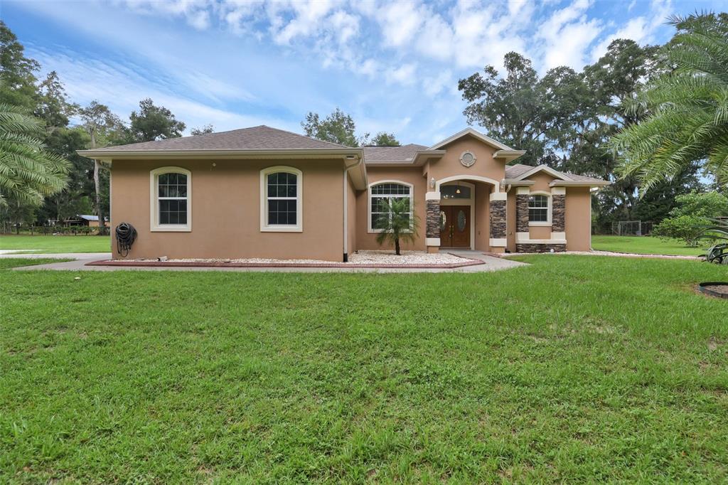 a front view of house with yard and green space