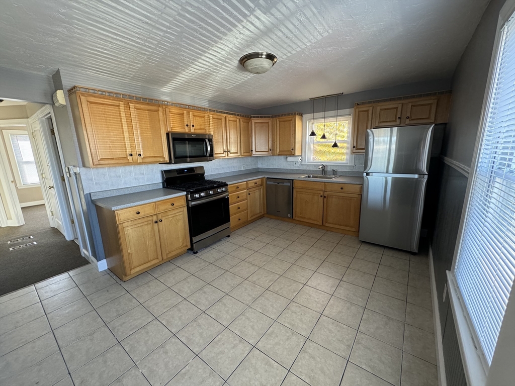 a kitchen with a sink a microwave and refrigerator