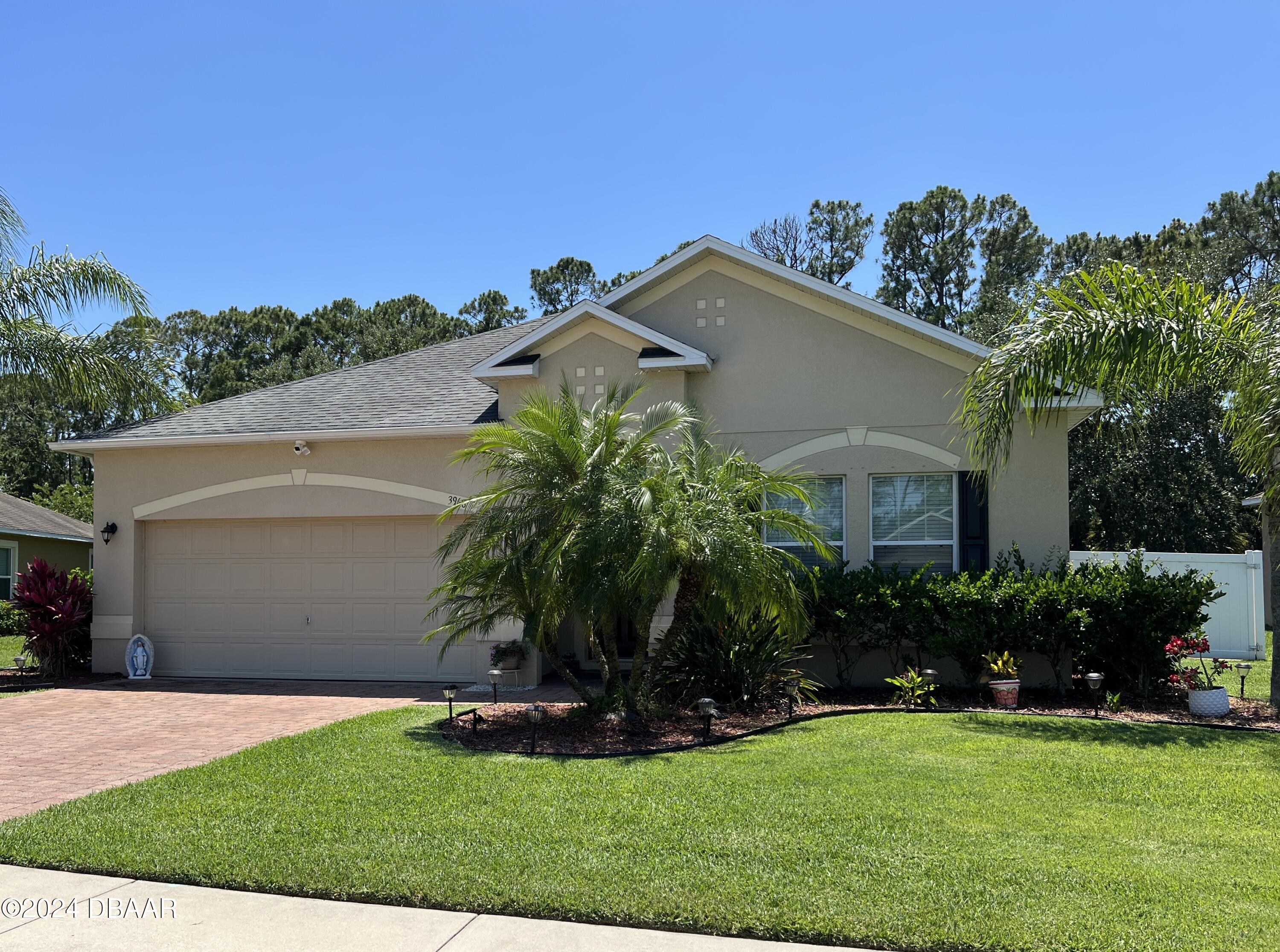 a front view of a house with a garden