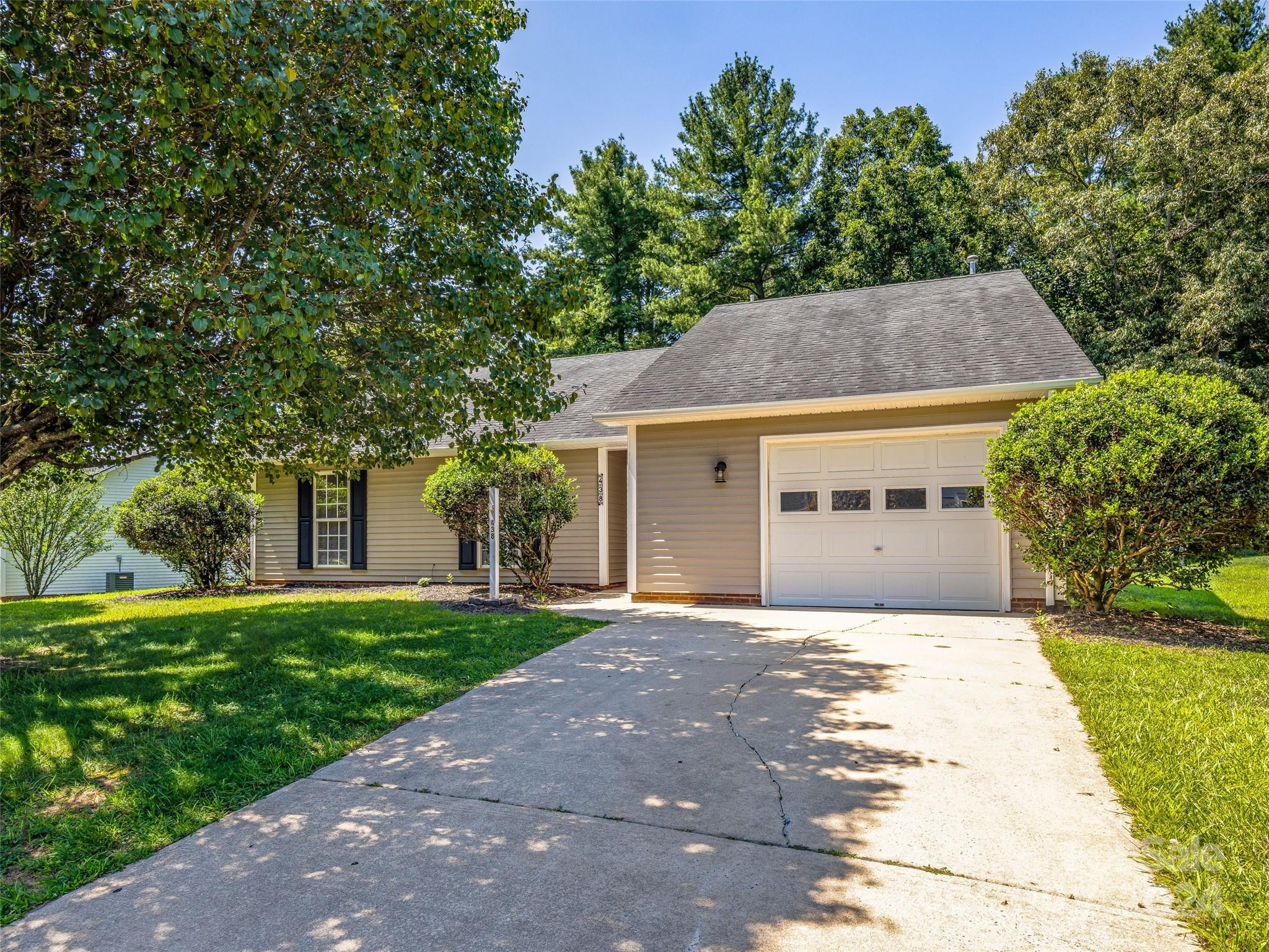 a front view of house with yard and trees