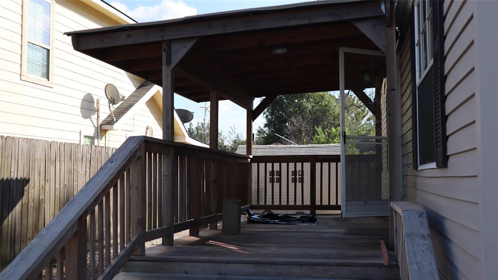 a view of balcony with wooden floor and fence