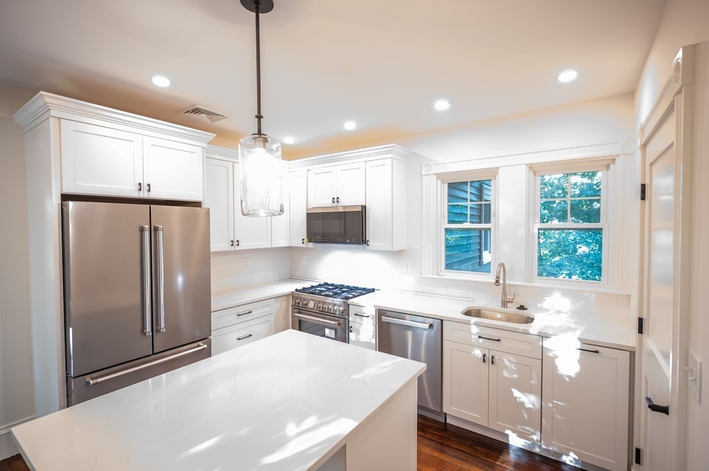 a kitchen with refrigerator cabinets and a table