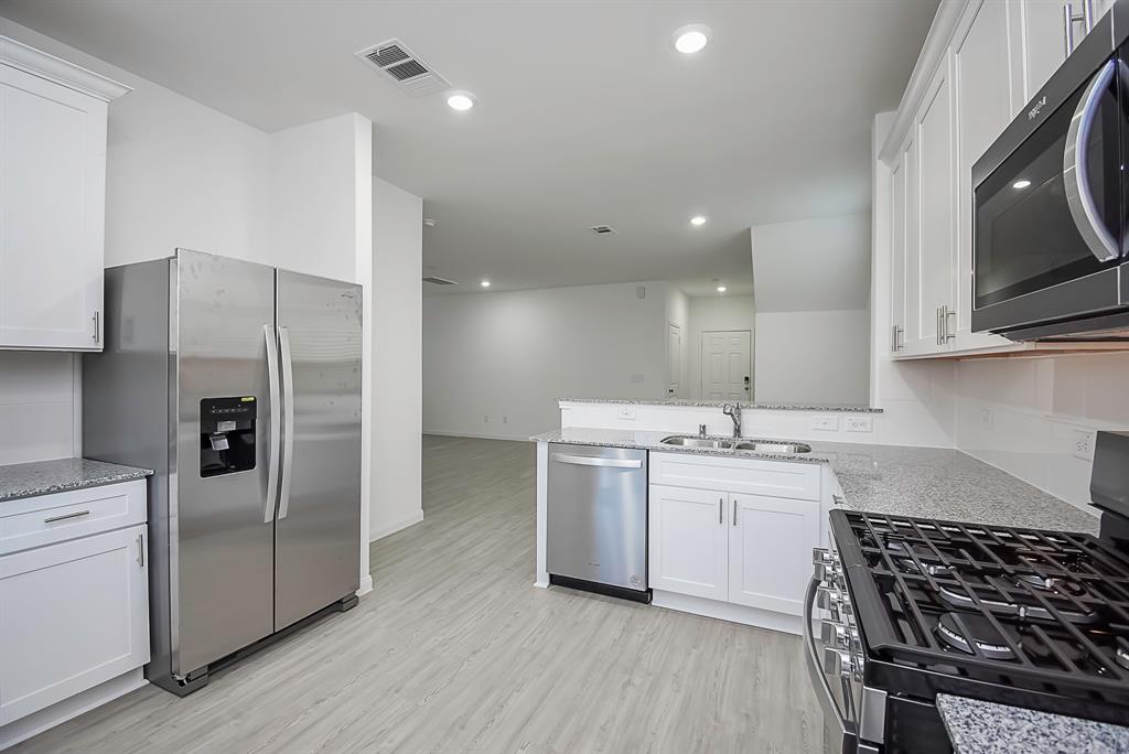 a kitchen with a sink stove and refrigerator