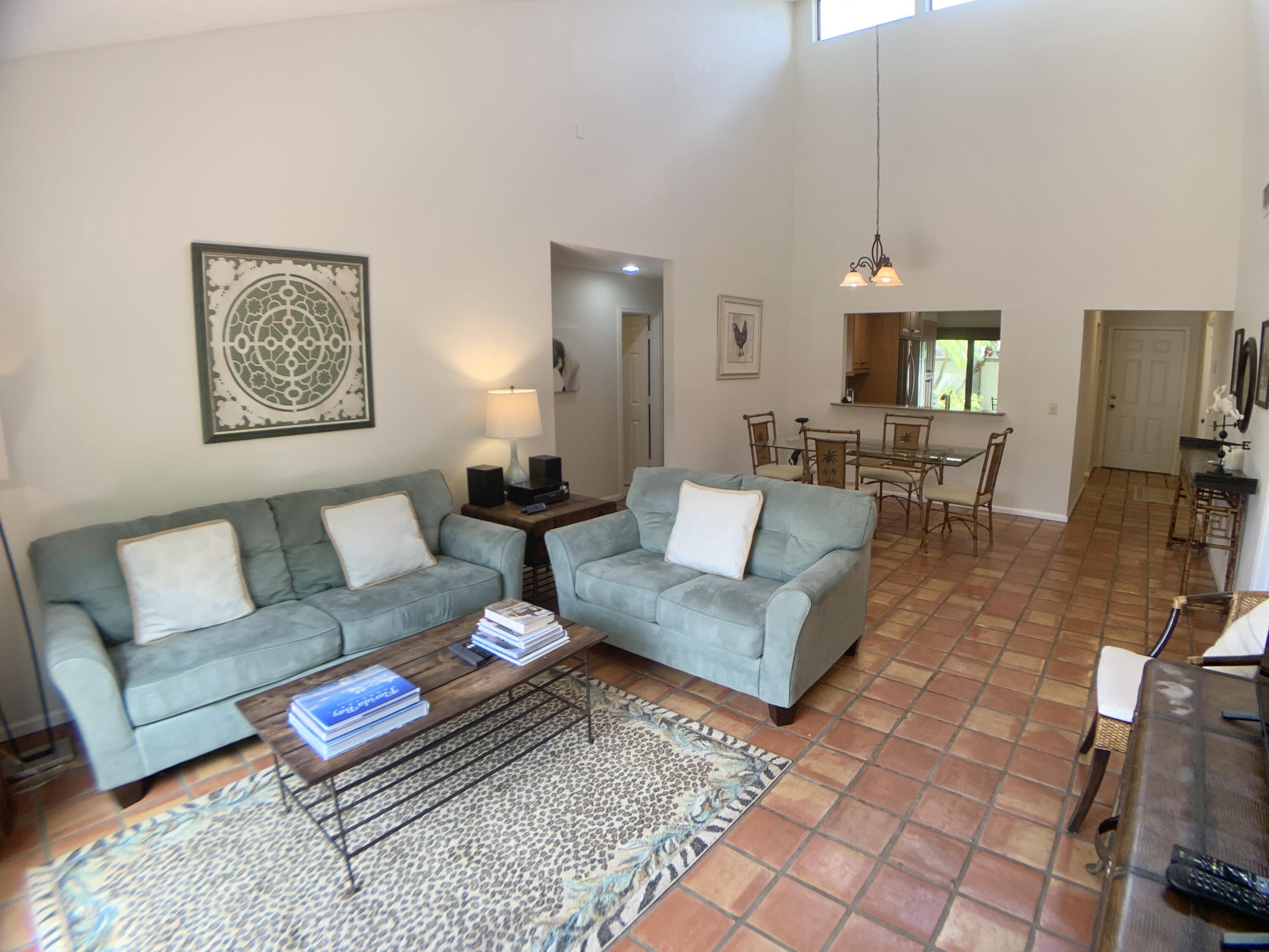 a living room with furniture a rug and a table