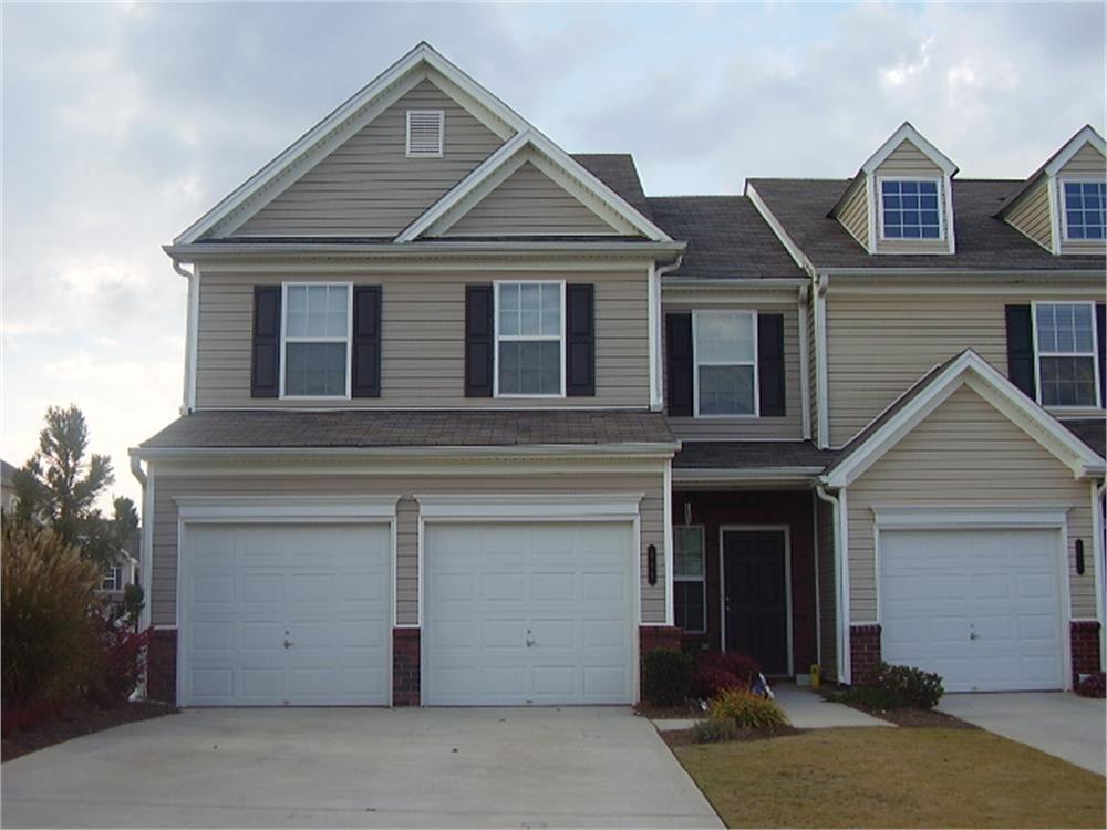 a front view of a house with a garage