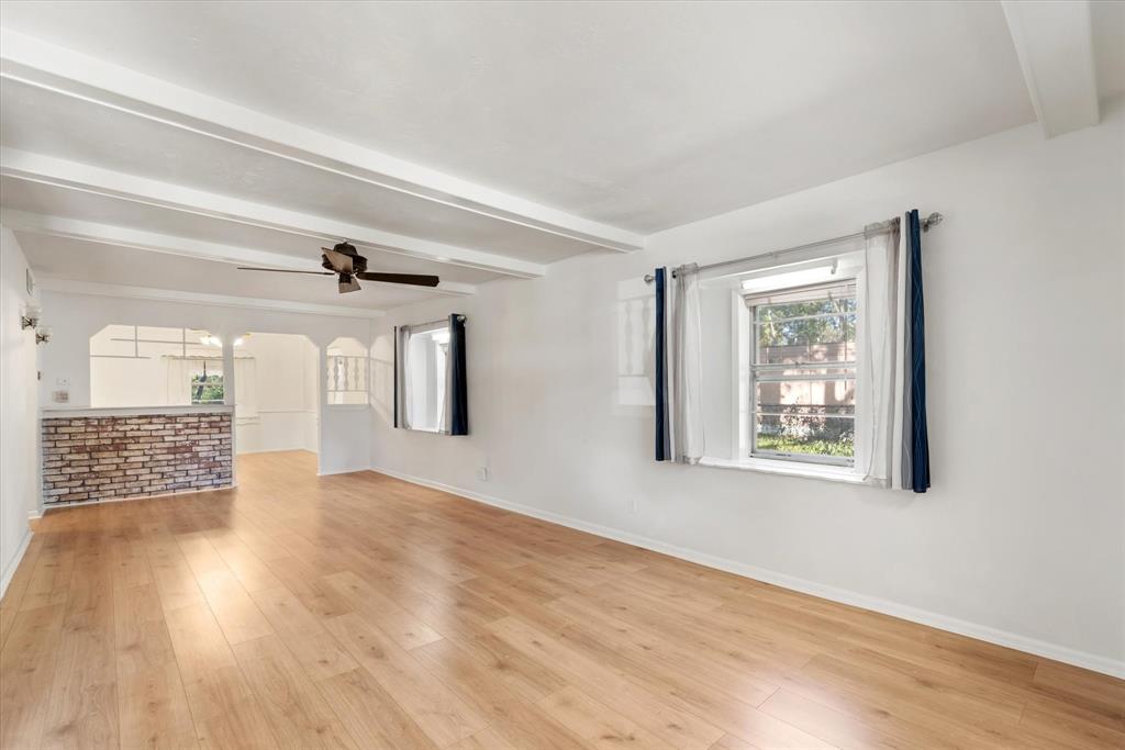 Step inside to be greeted by a huge living area! Complete with laminate flooring, window treatments and decorative beams on the ceiling.