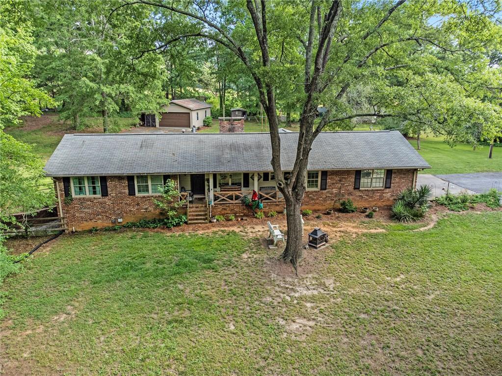 a view of house with a yard