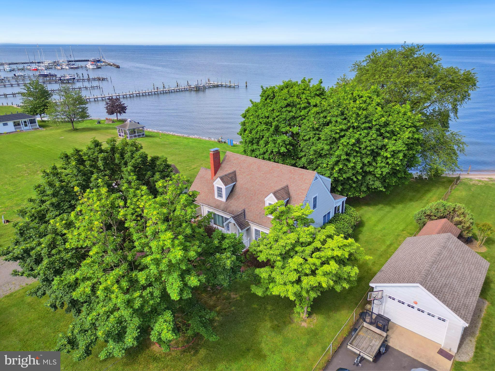 an aerial view of a house with a garden and lake view