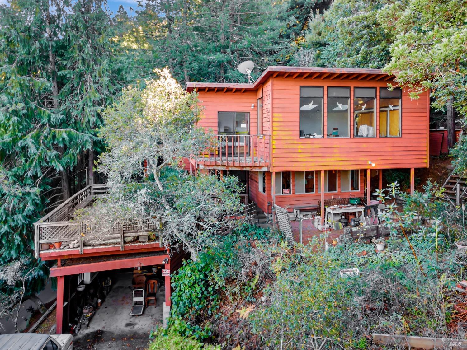 a backyard of a house with wooden chairs and wooden fence