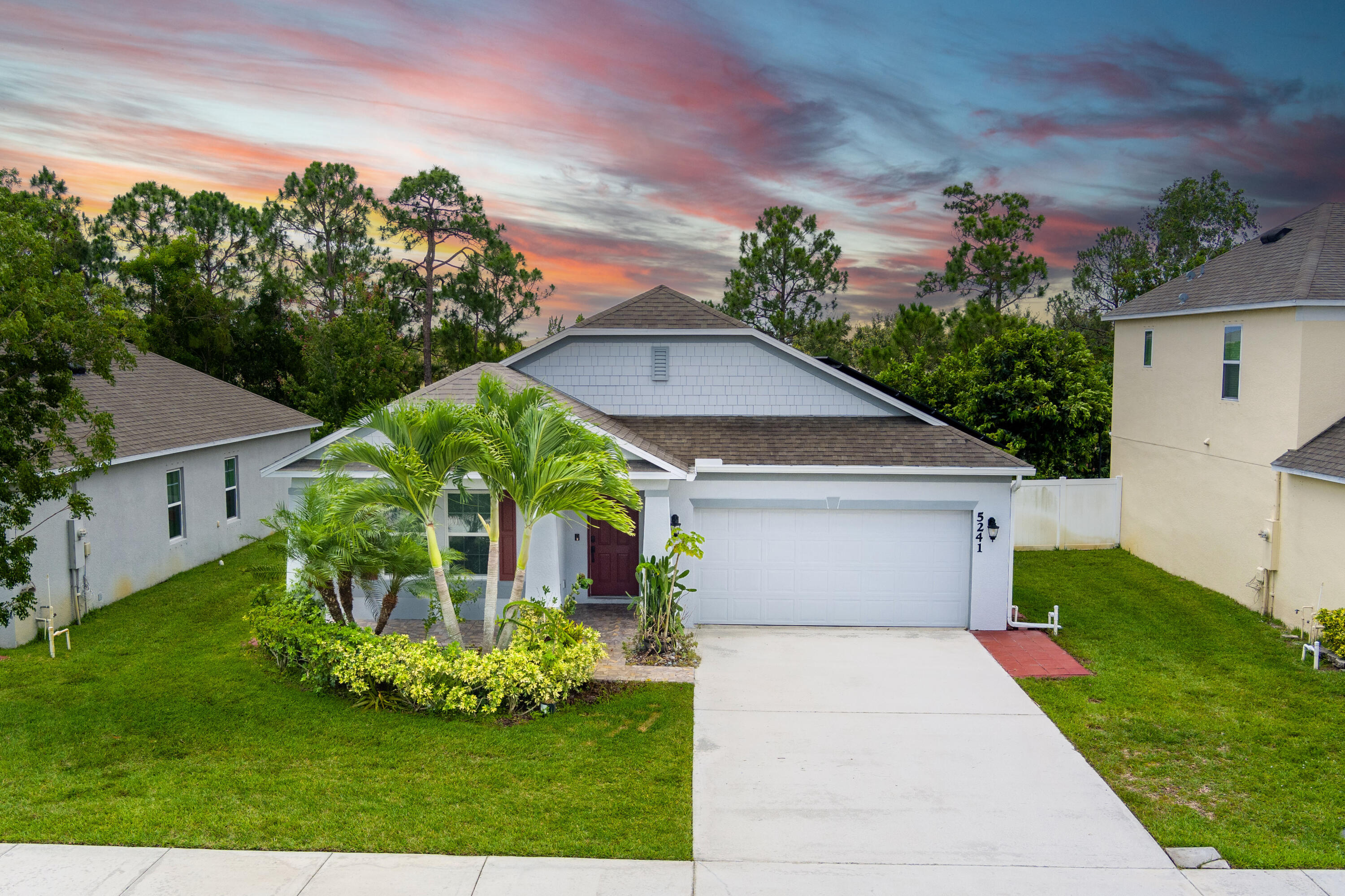 a front view of a house with a garden