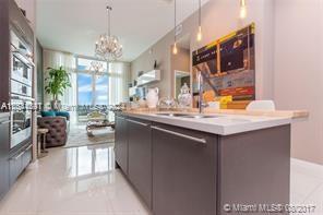 a kitchen with sink and view of living room