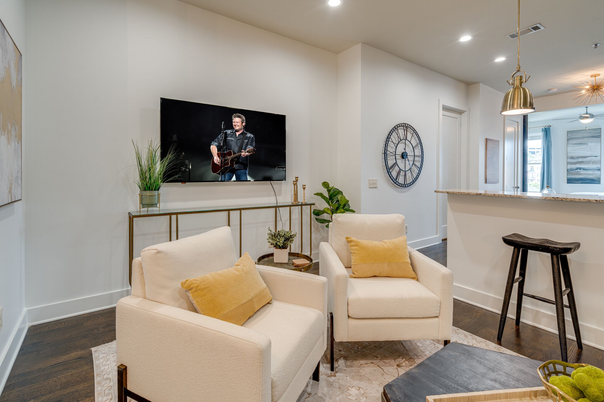 a living room with furniture and wooden floor