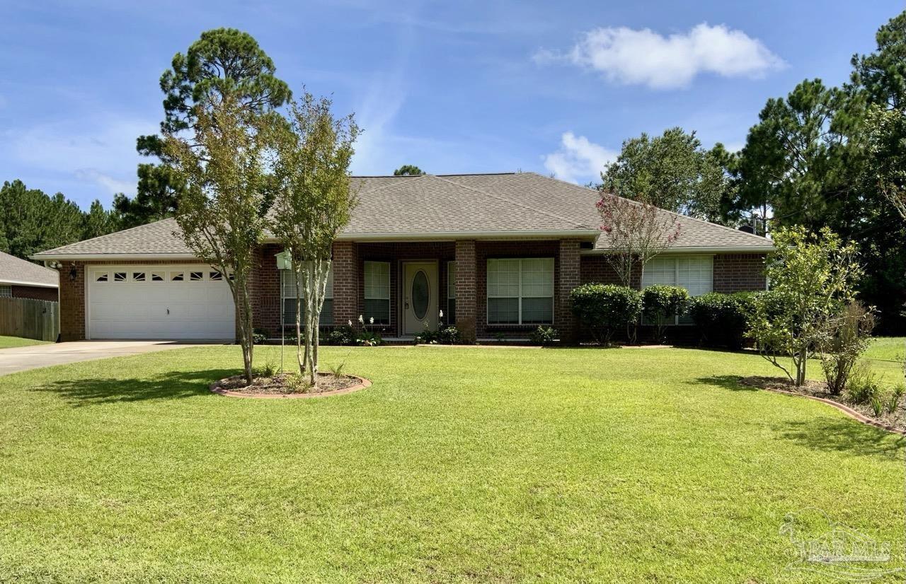 a view of a house with pool and a yard