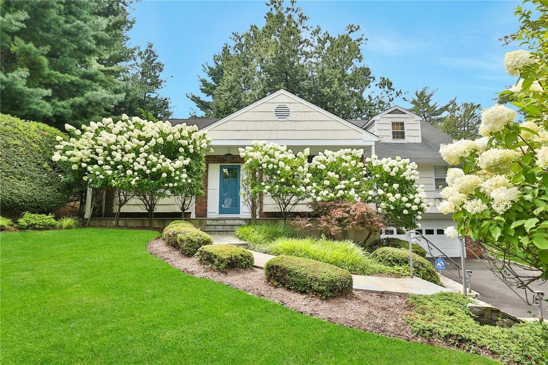 a front view of a house with garden