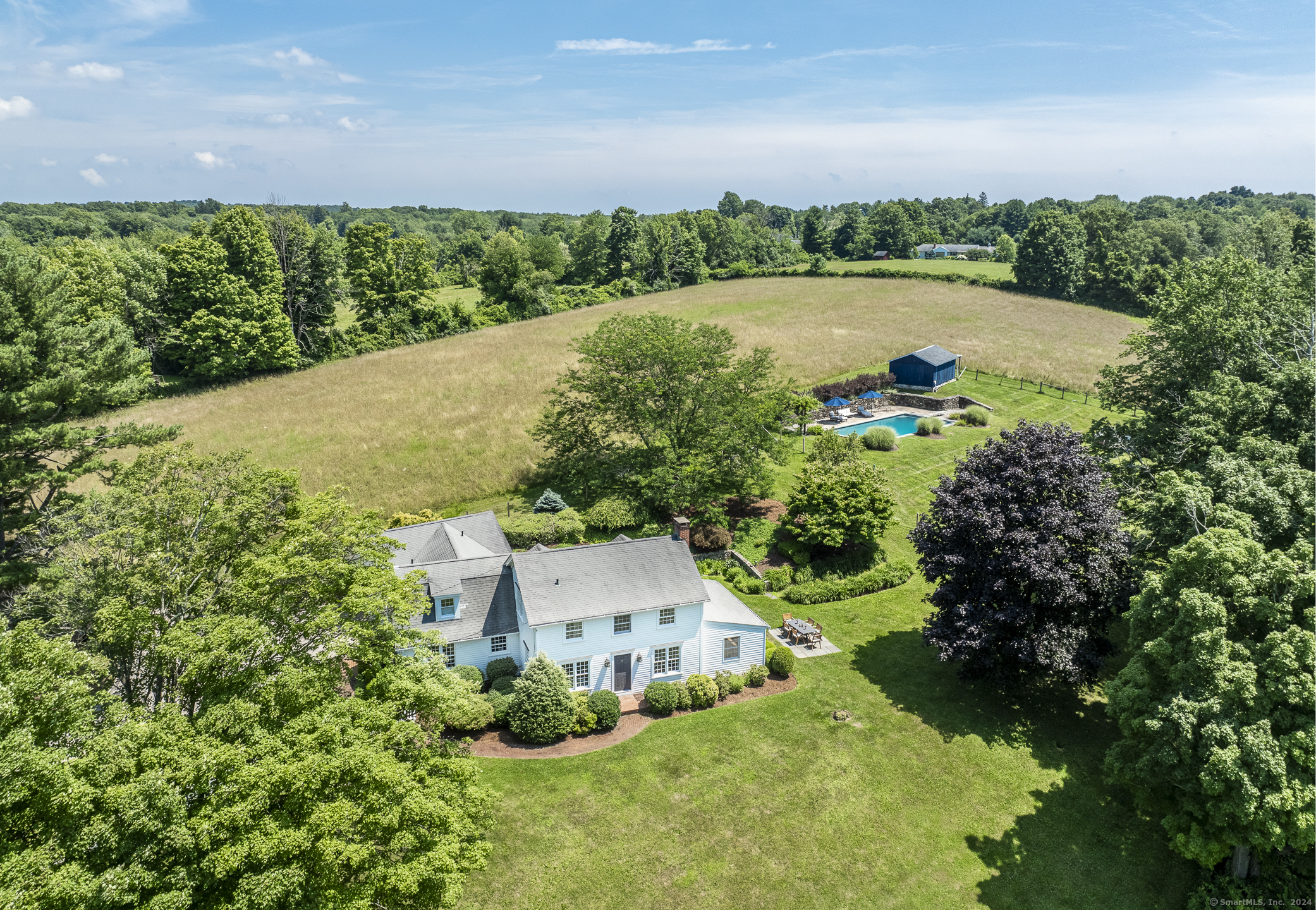 an aerial view of a house with a yard and lake view