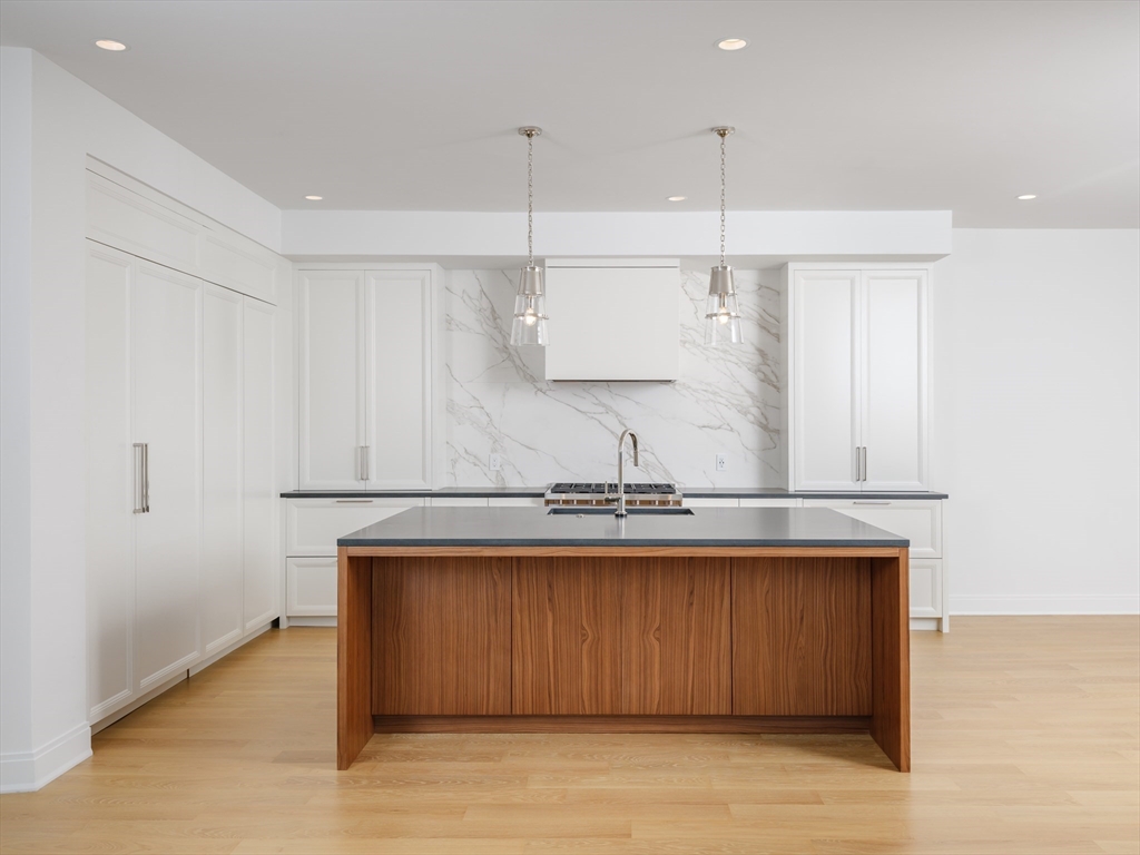 a view of a kitchen with a sink stainless steel appliances and cabinets