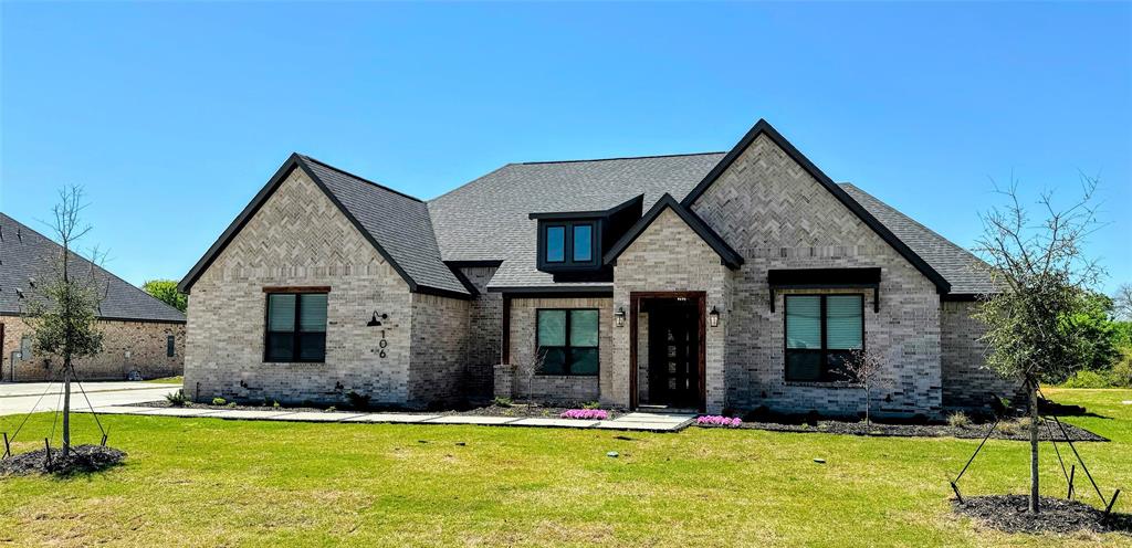 a front view of a house with a yard