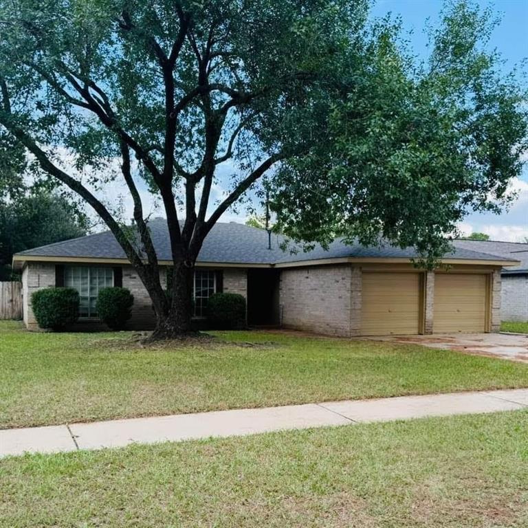 a front view of a house with yard and green space