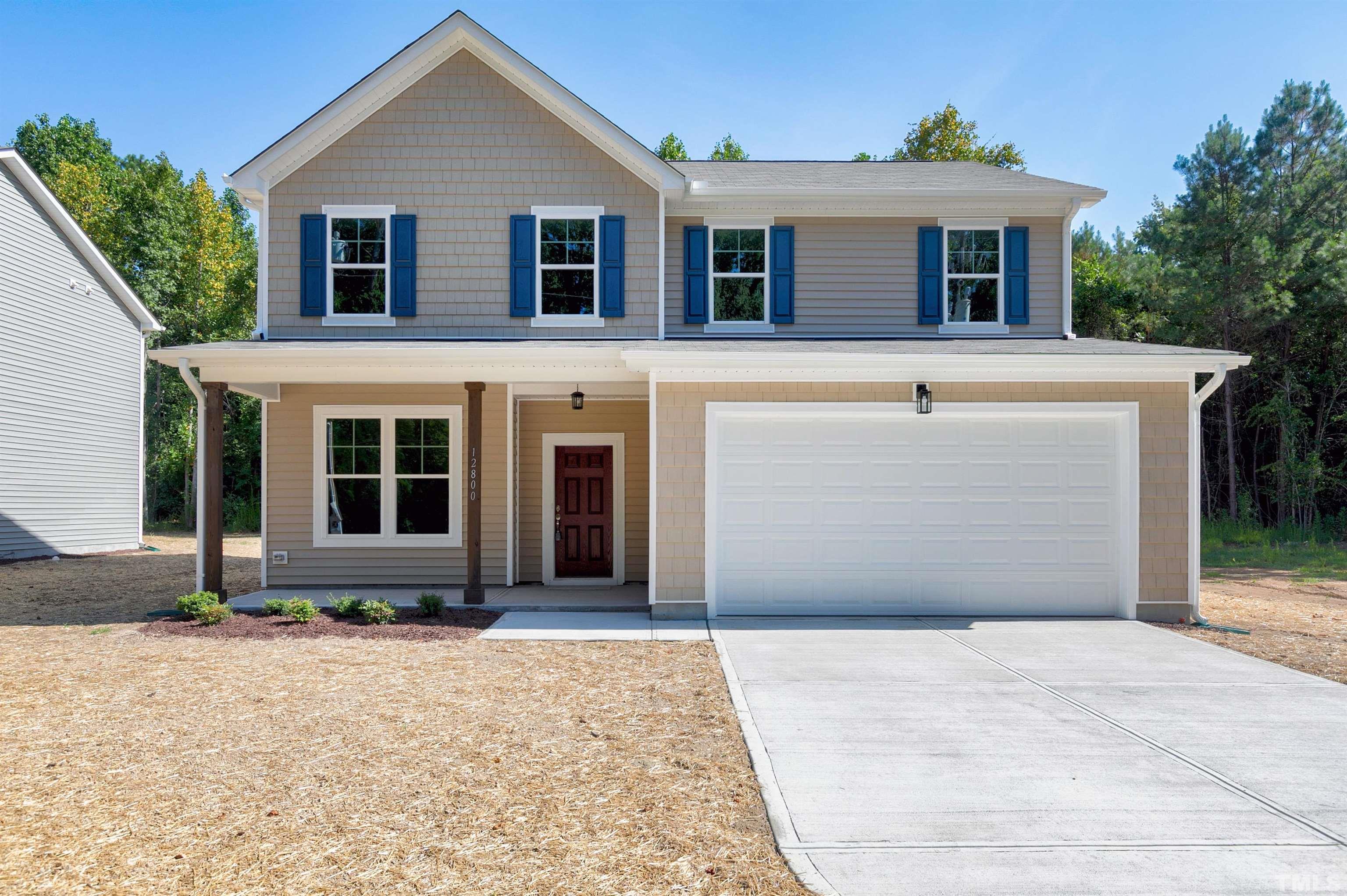 a front view of a house with yard