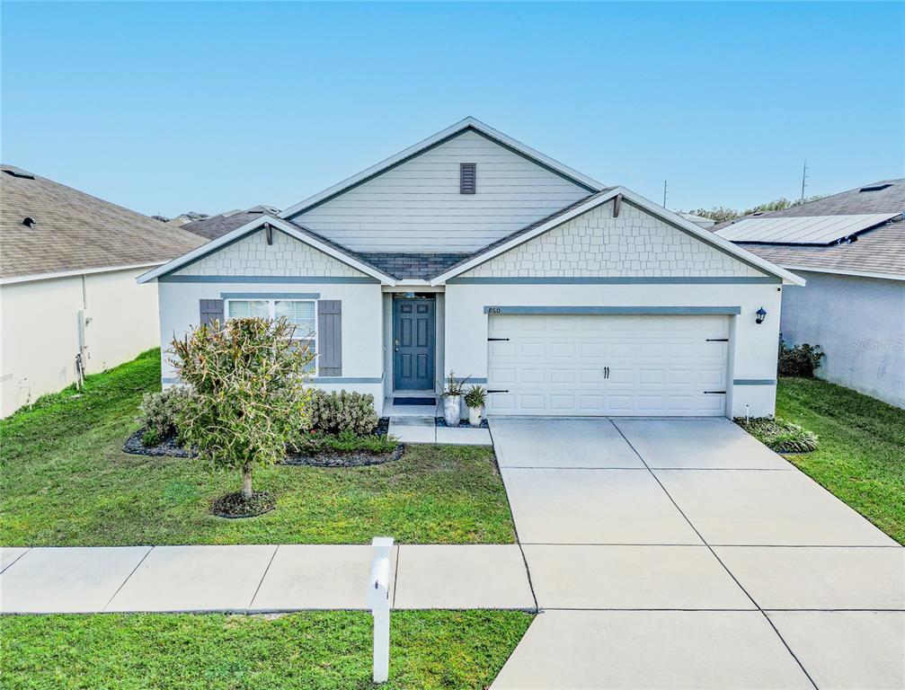 a front view of house with yard and green space