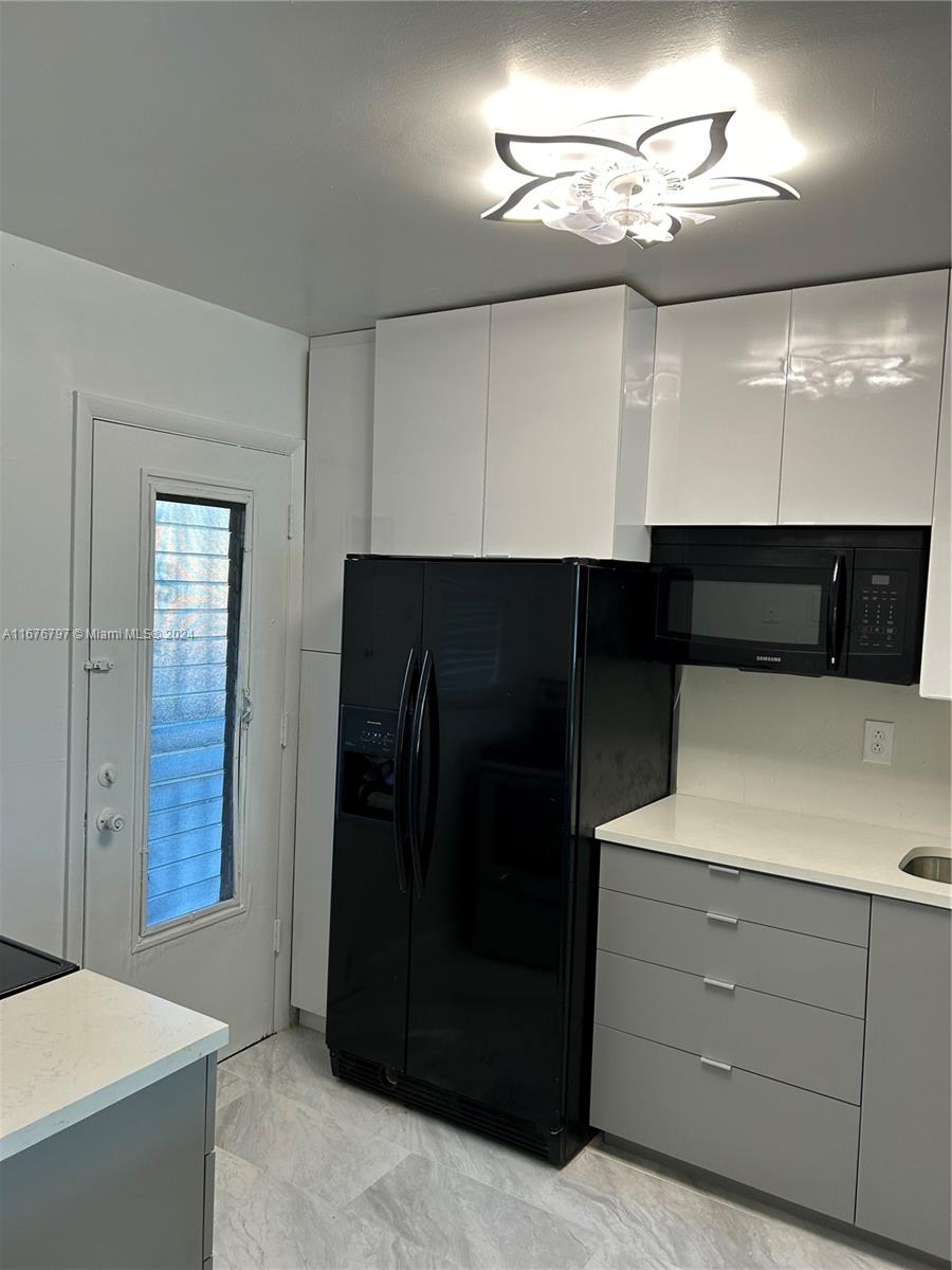 a kitchen with a refrigerator and cabinets