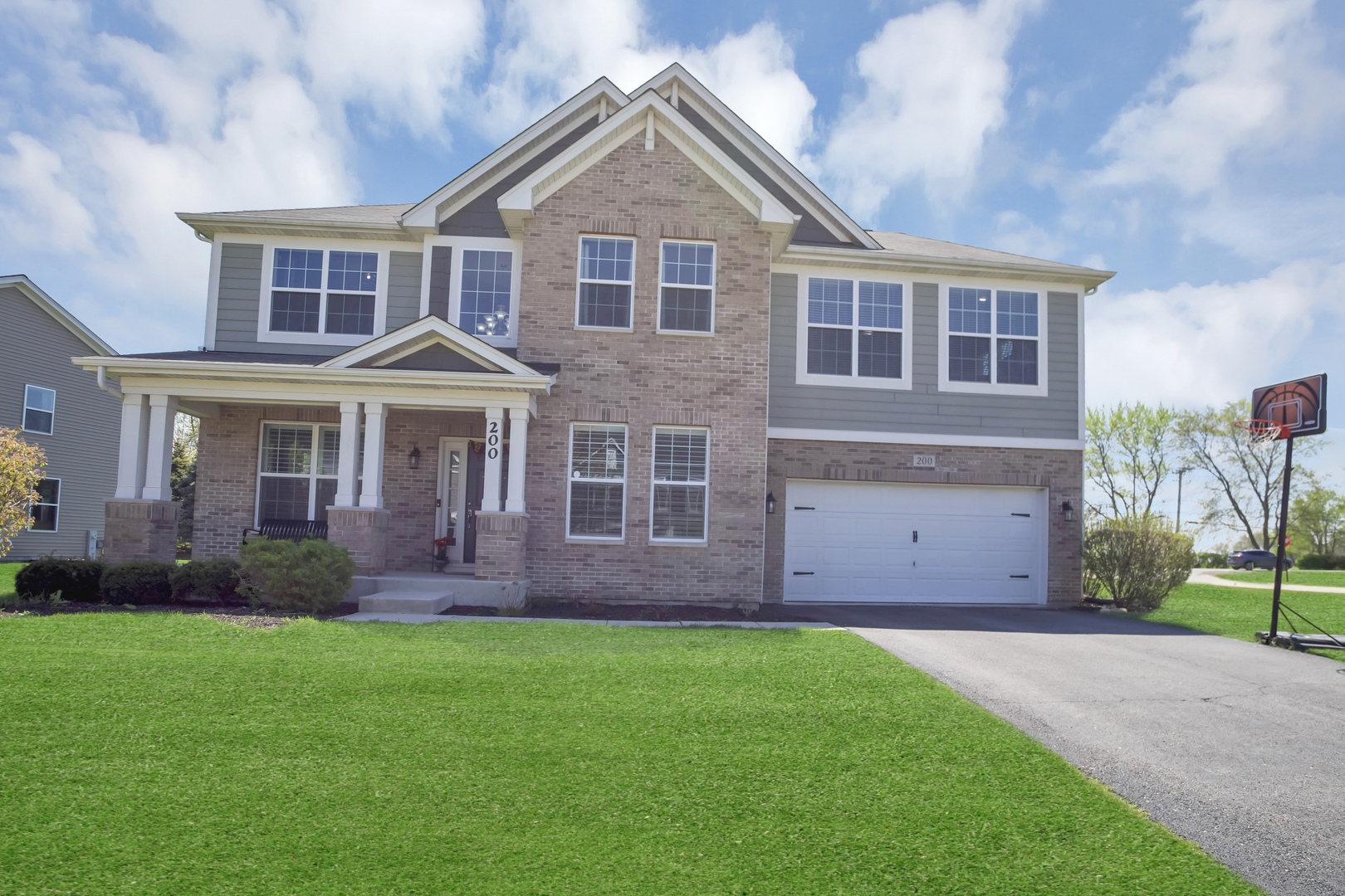 a front view of a house with a yard and porch